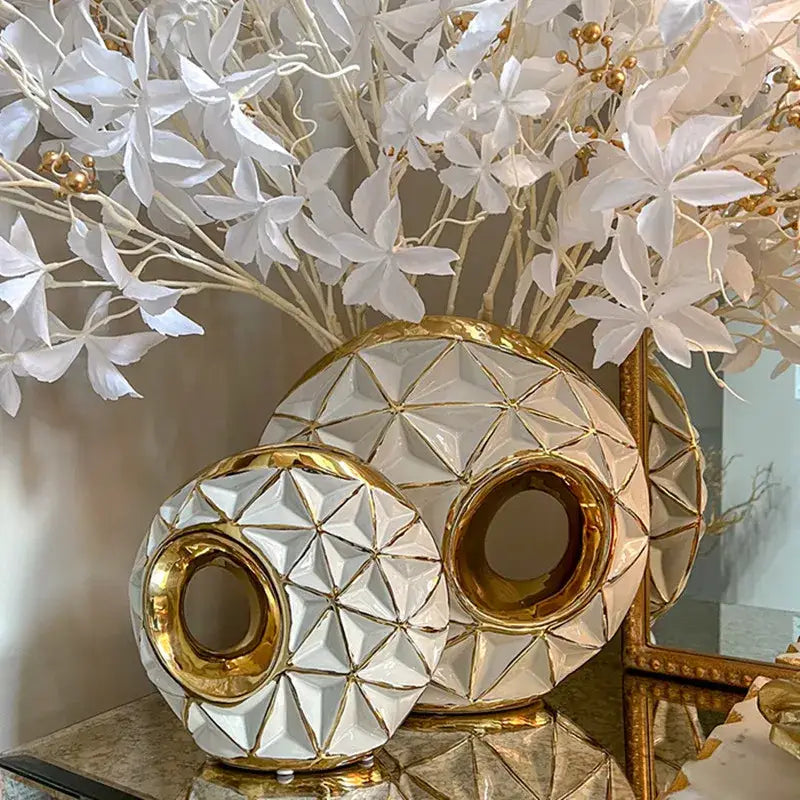 Textured white and golden ceramic vase with geometric detailing and cutouts for living room decorbites golden ceramic decor