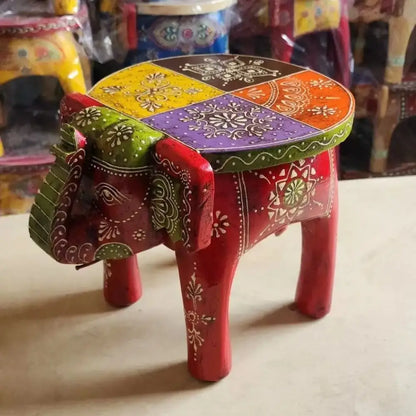 Vibrant red decorbites handmade elephant stool with colorful patterned top and white floral designs for thai style ethnic decor