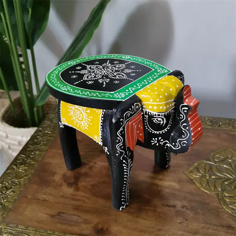 Hand-painted decorbites handmade elephant stool with black base yellow red accents and intricate white floral patterns
