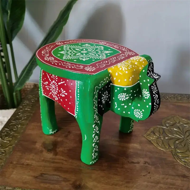 A vibrant green handmade elephant stool with red yellow white mandala patterns for thai style ethnic decorbites decor