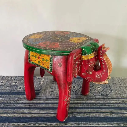 Vibrant red decorbites handmade elephant stool with intricate gold and green patterns for thai style ethnic decor