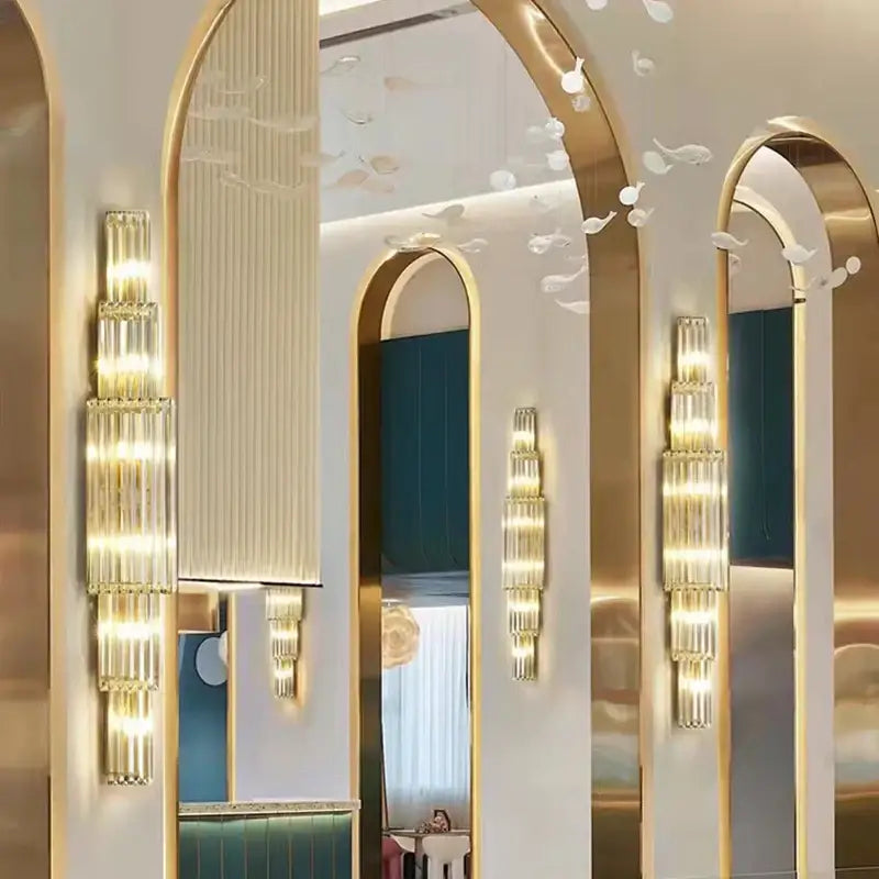 Tiered golden decorbites clear glass wall lamp with stacked translucent cylinders and warm glow for dining room lighting