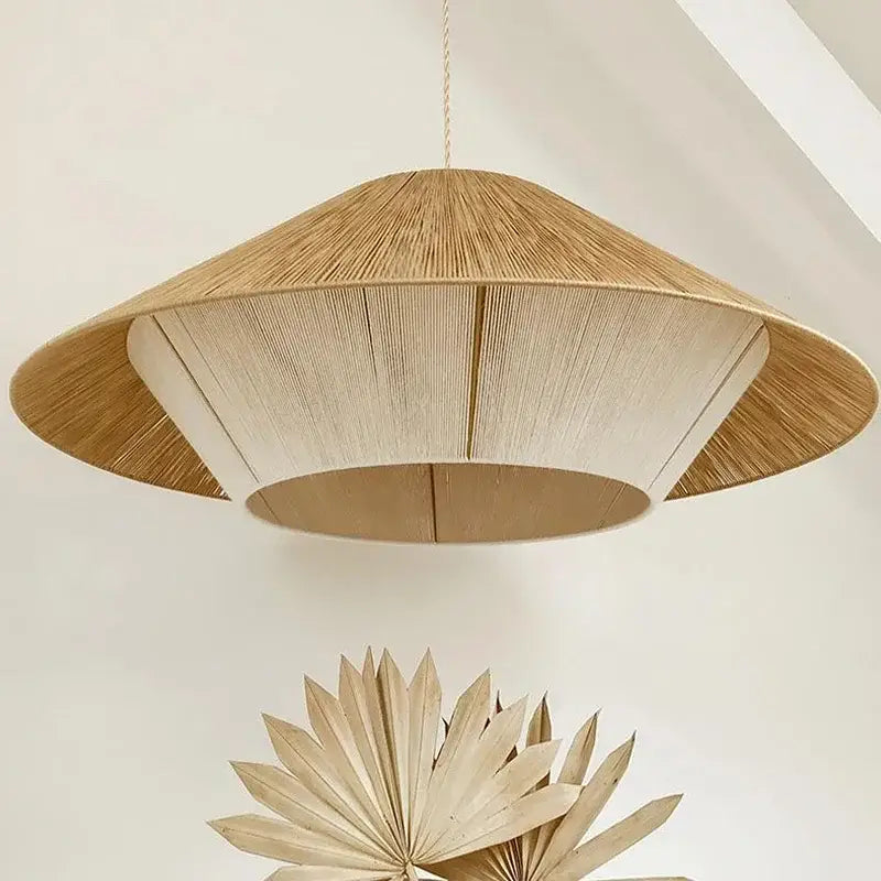 A woven conical pendant light with natural beige finish featuring hemp rope rattan radial texture for warm dining room decorbites hemp rope