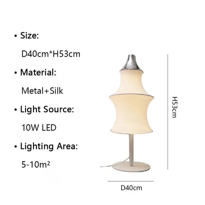 A sleek floor lamp with a metallic base and tiered cream silk japanese shade for soft living room lighting decorbites cream silk