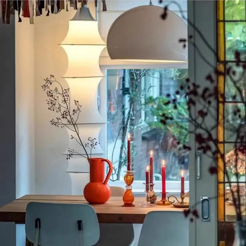Vibrant orange ceramic pitcher shown alongside decorbites cream silk japanese tiered floor lamp for soft living room lighting