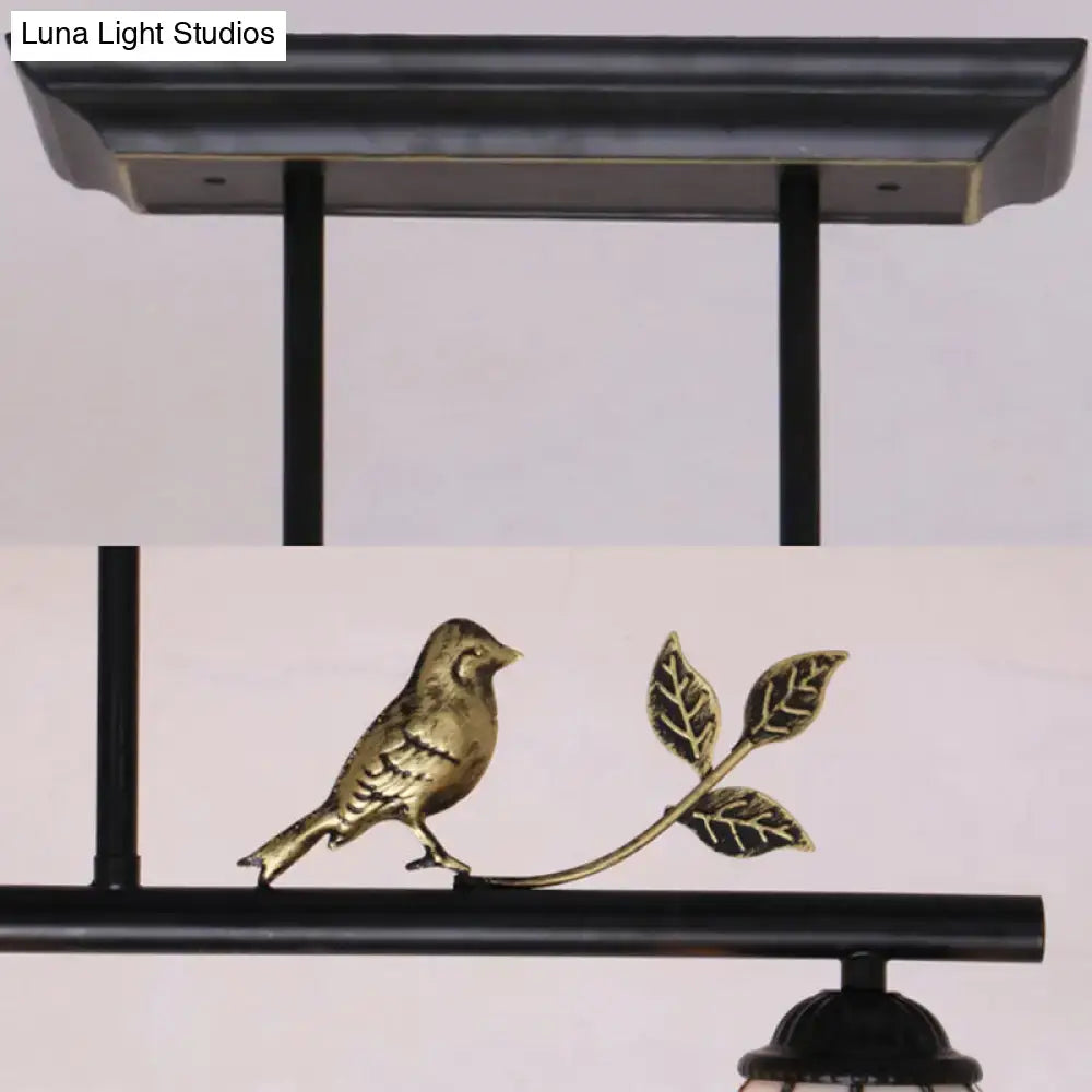 Gold-toned bird perched on leafy branch accent of decorbites tiffany style dome shade island lighting in black antique brass