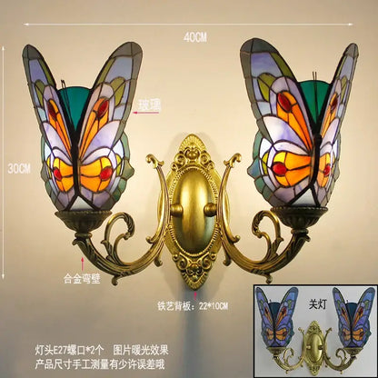 Ornate gold-toned butterfly glass sconces with vibrant orange and purple shades for bedroom wall lamps by decorbites