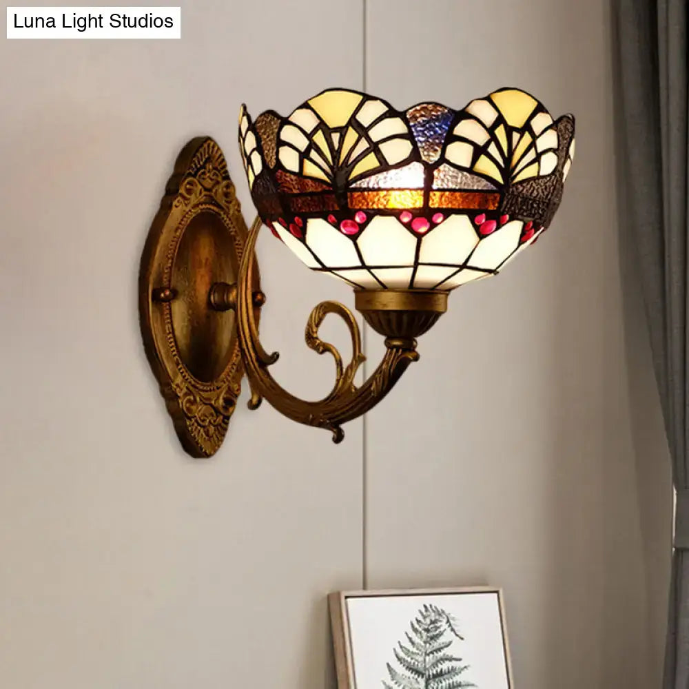 Antique brass-finished tiffany gold cut floral stained glass wall sconce with cream yellow and red hues for bedroom lighting