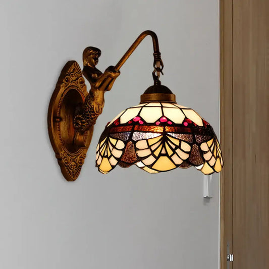 Antique brass-finished wall sconce with tiffany gold cut floral stained glass lampshade in amber cream and pink hues