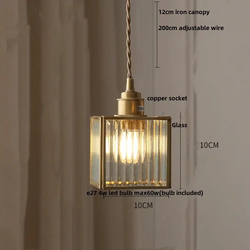 A brass-framed rectangular glass led pendant lamp with ribbed panels and copper socket for dining room lighting
