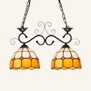 Ornate black wrought iron ceiling light with two amber and cream stained glass shades ideal for dining room lighting