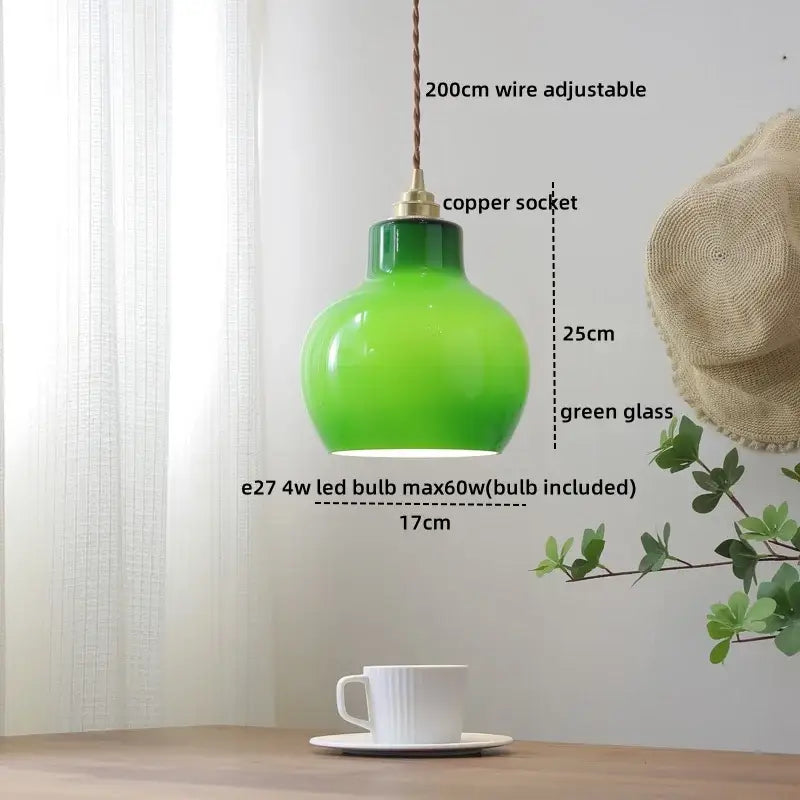 A vibrant green glass copper led pendant lamp with braided wire suspension for dining room lighting