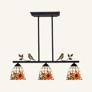 Black antique brass chandelier with three stained glass sunflower shades and bird accents in tiffany style design