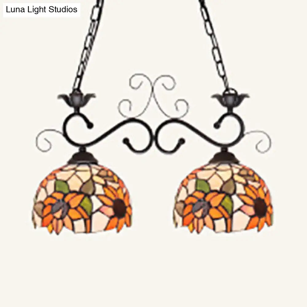Vibrant sunflower-themed stainless glass pendant light with ornate black wrought iron arms and chains for island lighting