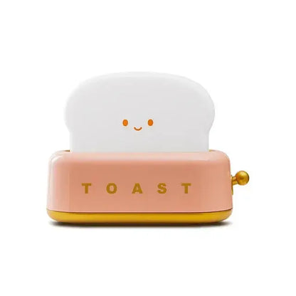 A cute pink and gold toaster shaped usb lamp night light with smiling bread and toast lettering for maker night light