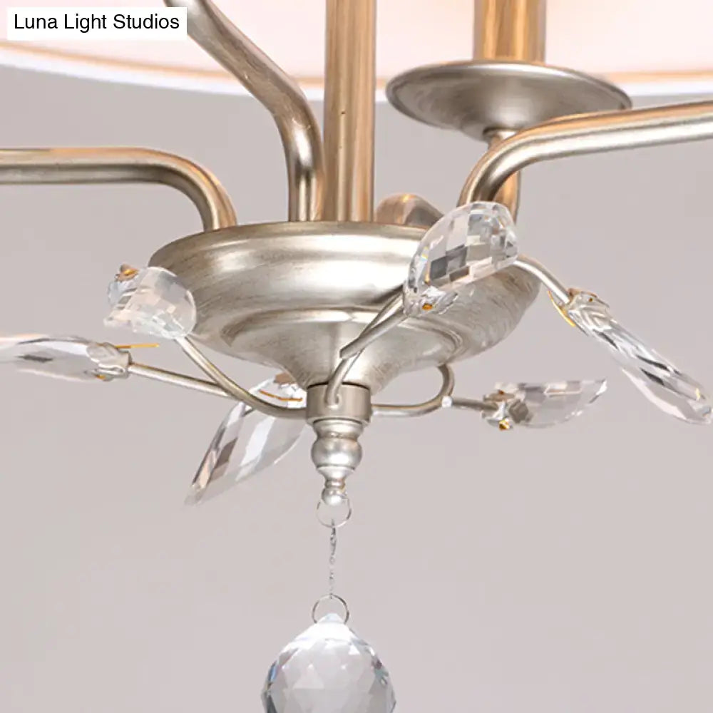 Traditional beige fabric crystal chandelier with silver-toned frame and teardrop-shaped crystal pendant for dining room island light