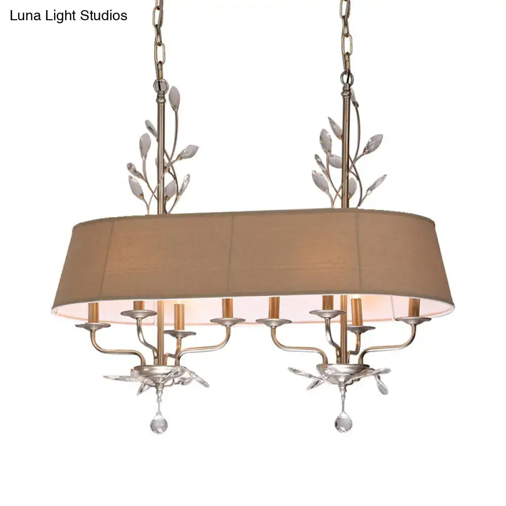 Traditional beige fabric crystal chandelier with silver metal leaf accents for dining room island lighting