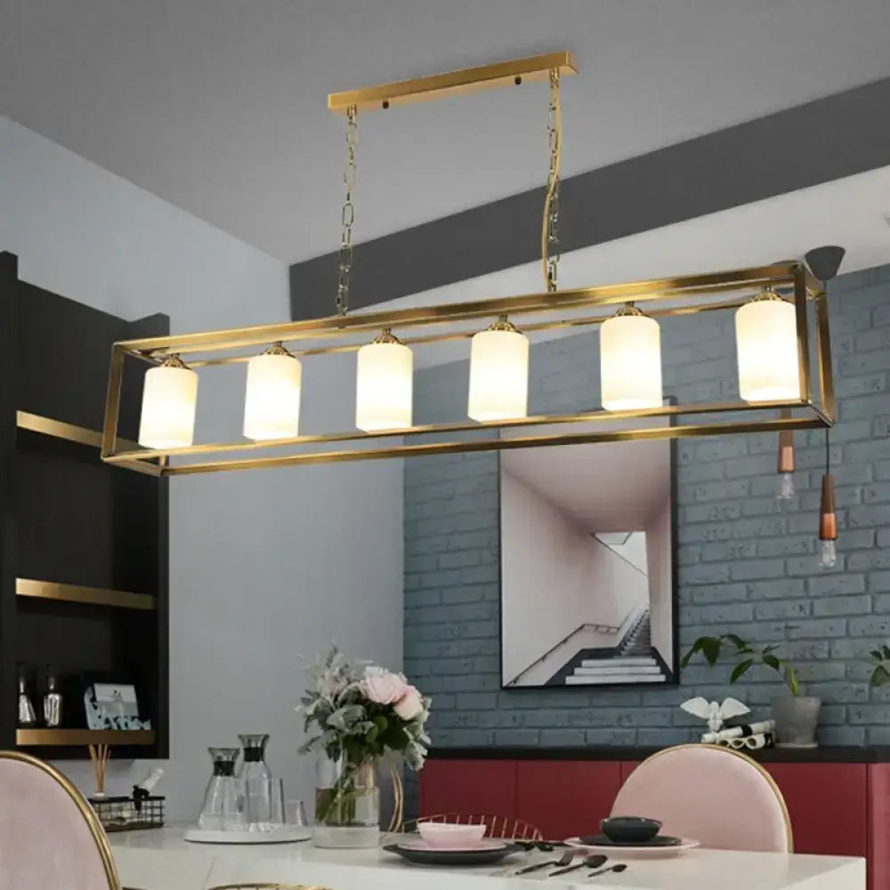 Gold-toned rectangular chandelier with five opal glass frosted shades suspended by chains for traditional island lighting