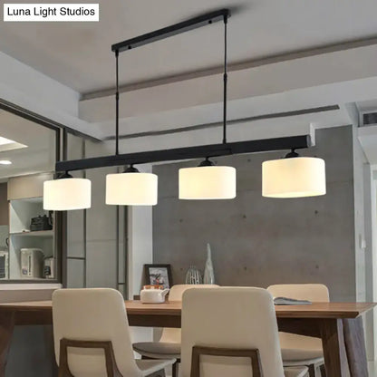 Black metal 4-light traditional drum island pendant with white cylindrical fabric shades for dining room lighting