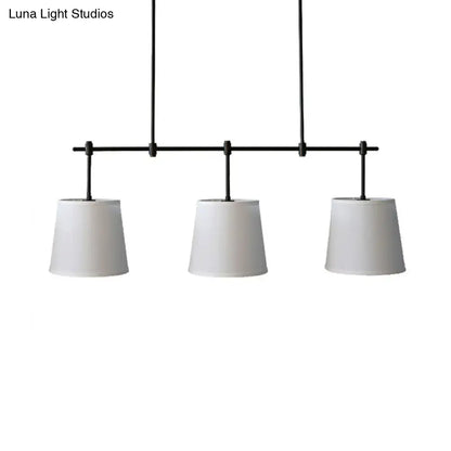 Traditional black metal pendant lighting with three white fabric shades for dining room or lights barrel island use