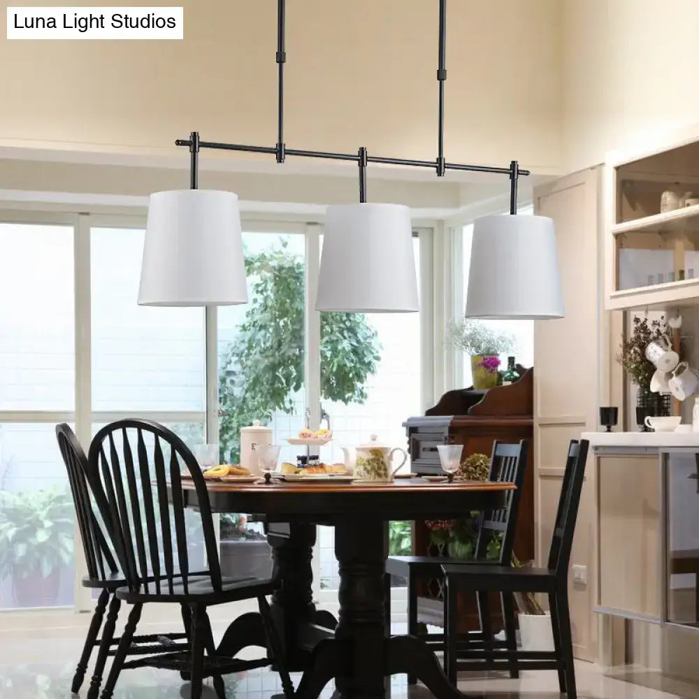 Black metal bar pendant lighting with three white cylindrical shades for dining room barrel island light