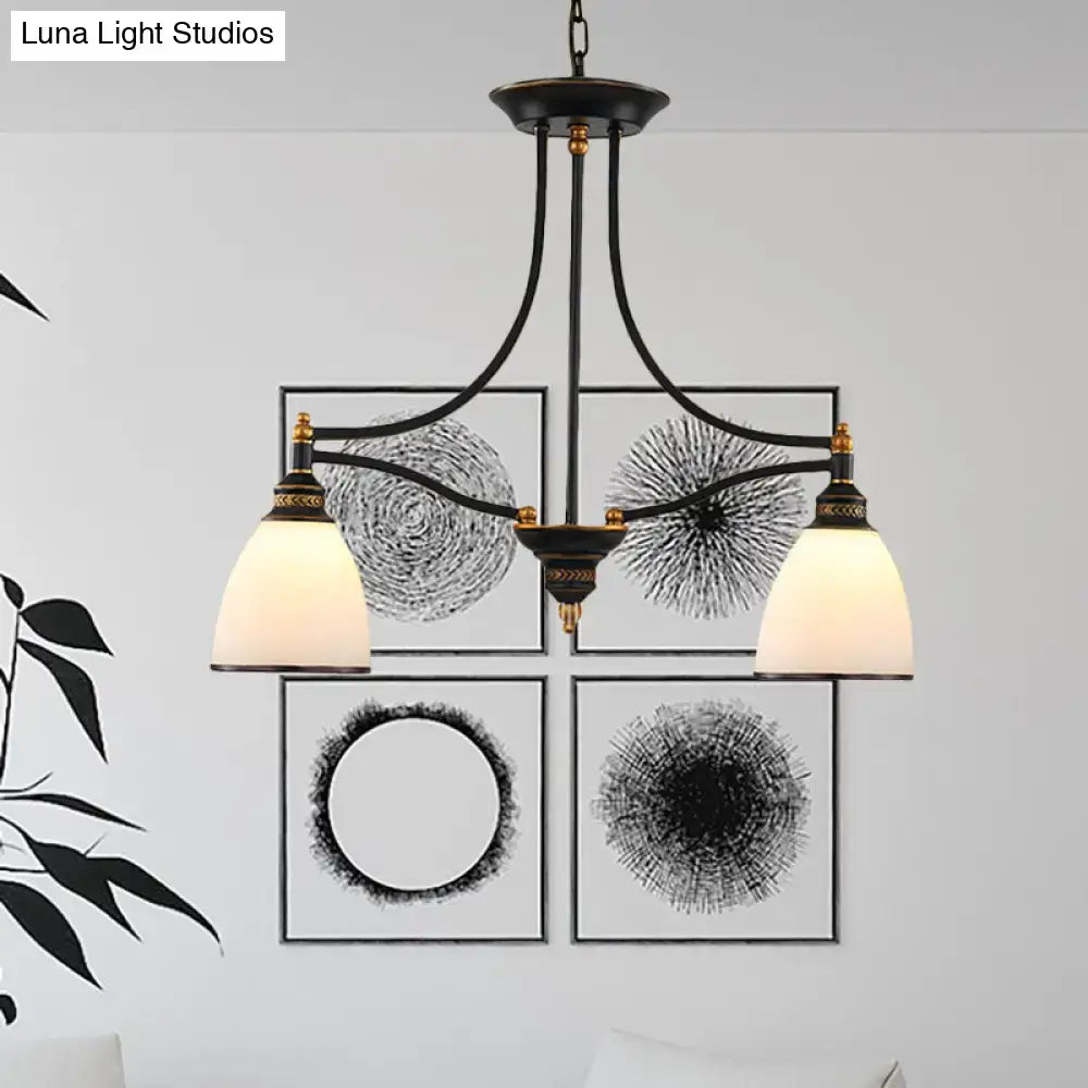 Black wrought iron pendant light with three cream barrel shades and gold accents suitable for 110v-120v use