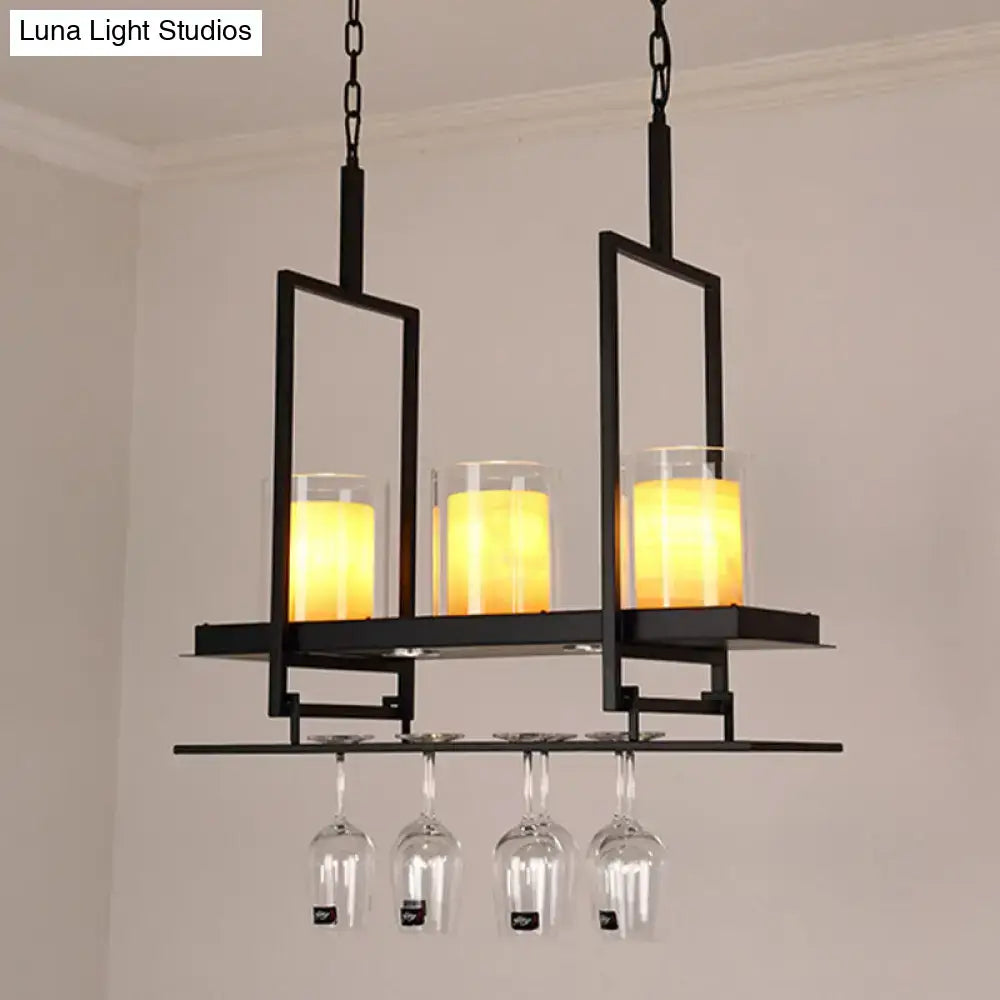 Black metal chandelier with three glowing amber candle lights and metal wine glass rack in traditional black marble finish