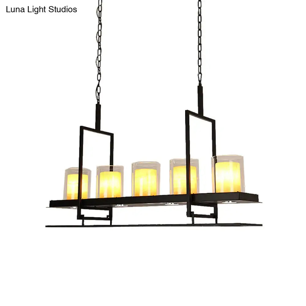 Black metal chandelier with five warm yellow candle lights in clear glass holders for heads cylinder island use