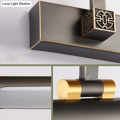 Bronze-finished door handle with square decorative pull and gold-toned accents paired with traditional black metal wall light 110v-120v