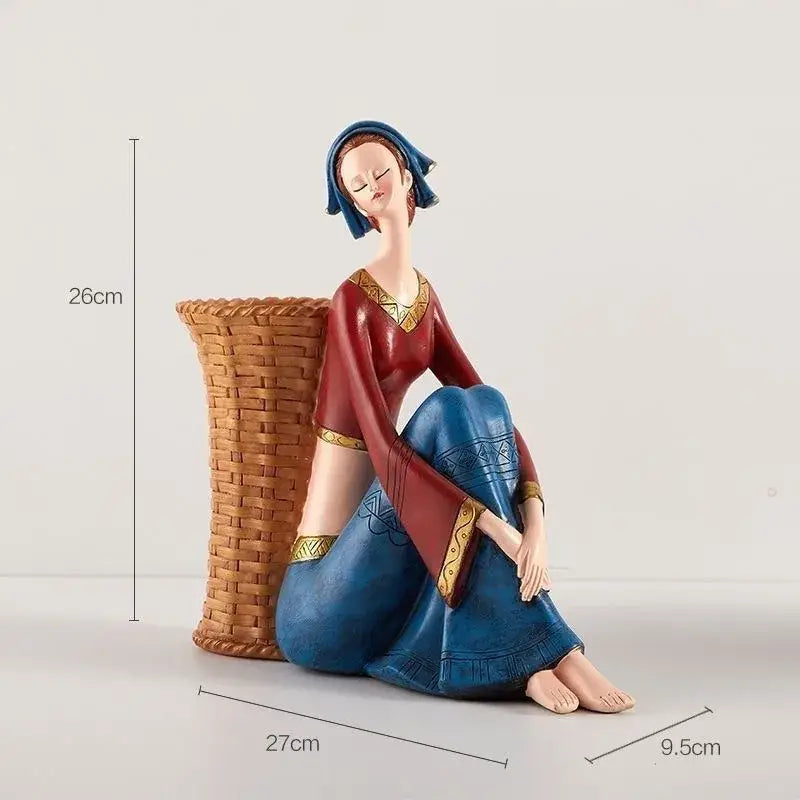 A detailed resin ornament of a woman in traditional red and blue attire from decorbites cute girls storage collection