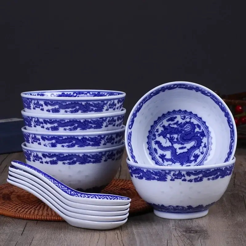 Set of six white porcelain dragon rice bowls with intricate blue dragon motifs and matching spoons for dining use