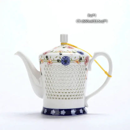 White ceramic tea pot with floral and dotted patterns and navy blue base band blue white porcelain decorbites blue white