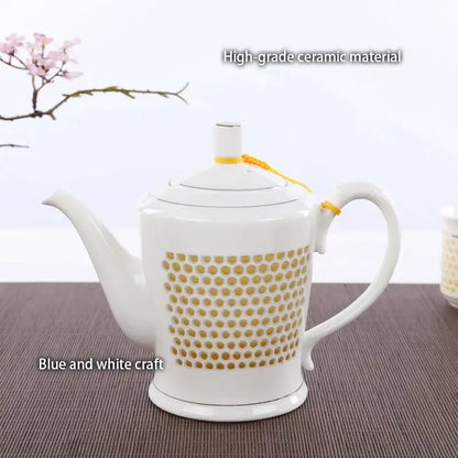 White ceramic tea pot with gold dot pattern and yellow ribbon from decorbites blue white porcelain teaware collection