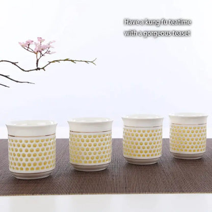 Set of four white ceramic teacups with yellow dot pattern and gold rims featured with decorbites blue white porcelain tea pot