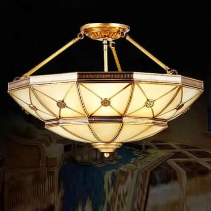 Gold-toned semi-flush mount fixture with 23.5’’/32’’ width and geometric octagonal glass shade for 220v-240v use