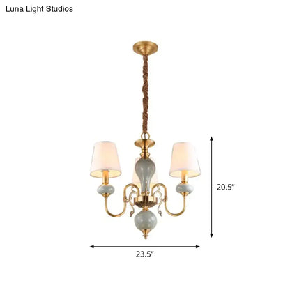 Traditional gold and blue chandelier with ceramic orbs and fabric shades for elegant dining room lighting