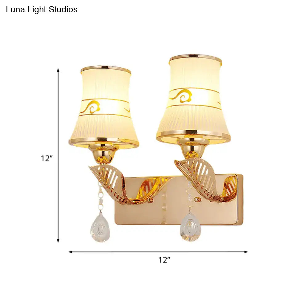 Traditional gold and cream wall sconce light with fabric shades gold swirls and crystal teardrop pendants for dining room