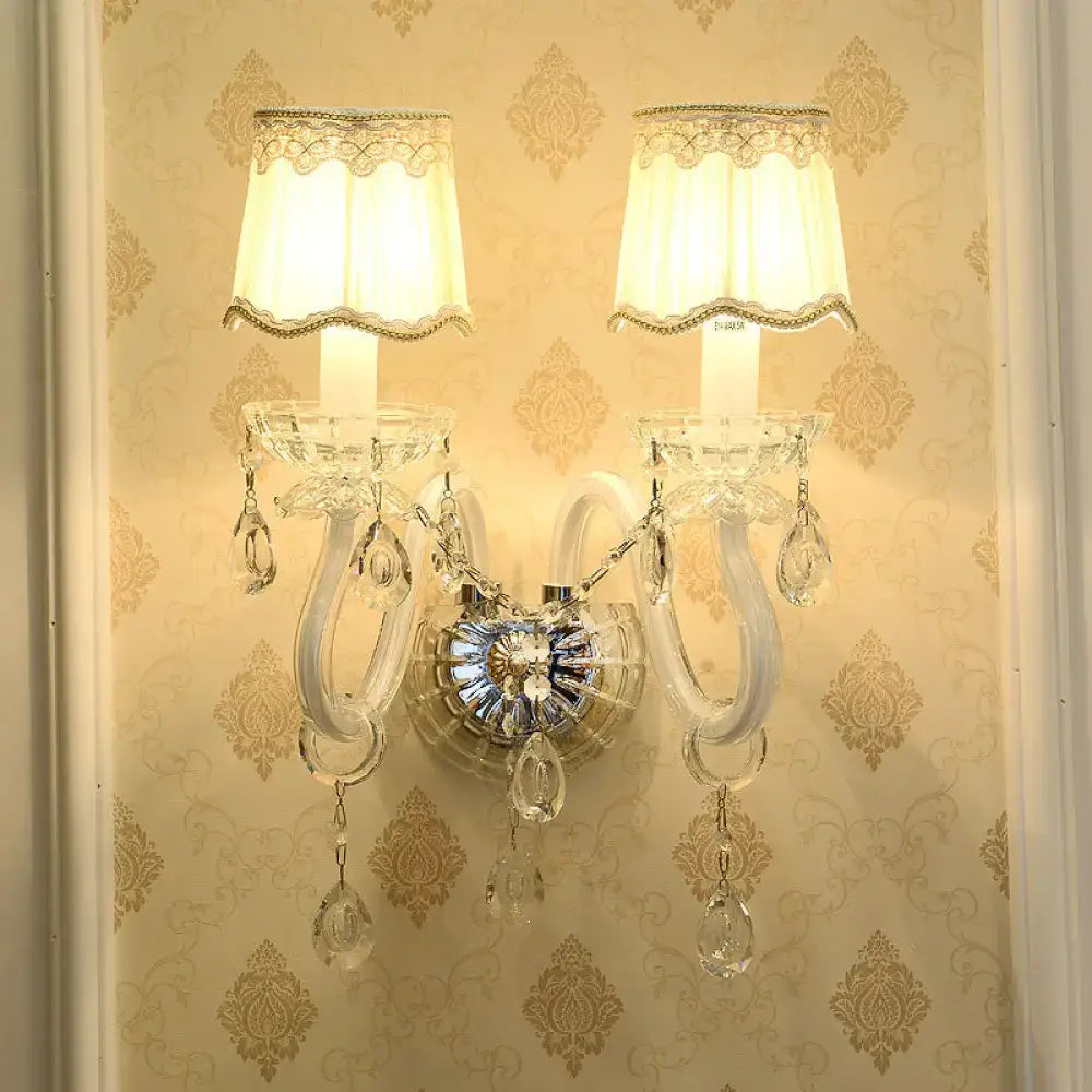 Traditional gold crystal candle wall lamp with two cream lampshades and clear crystal droplets for bedroom wall lamp