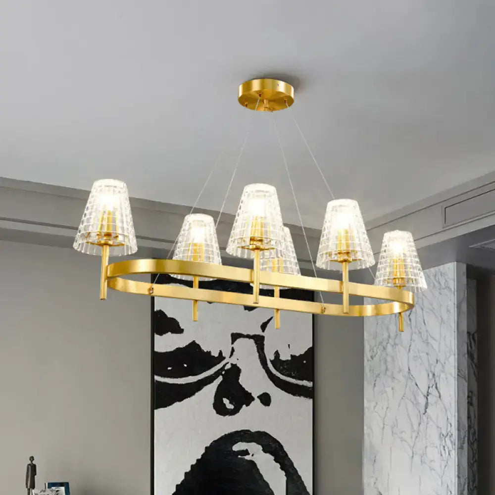 Traditional gold island pendant light with five textured glass shades and a sleek oval frame for dining room use