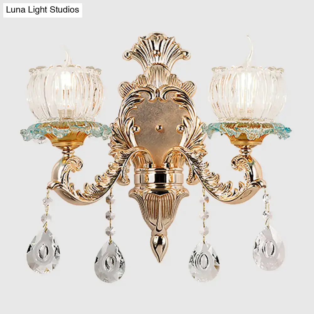 Traditional gold crystal wall sconce with e12 glass candle shades and dangling teardrop pendants for restaurant lighting