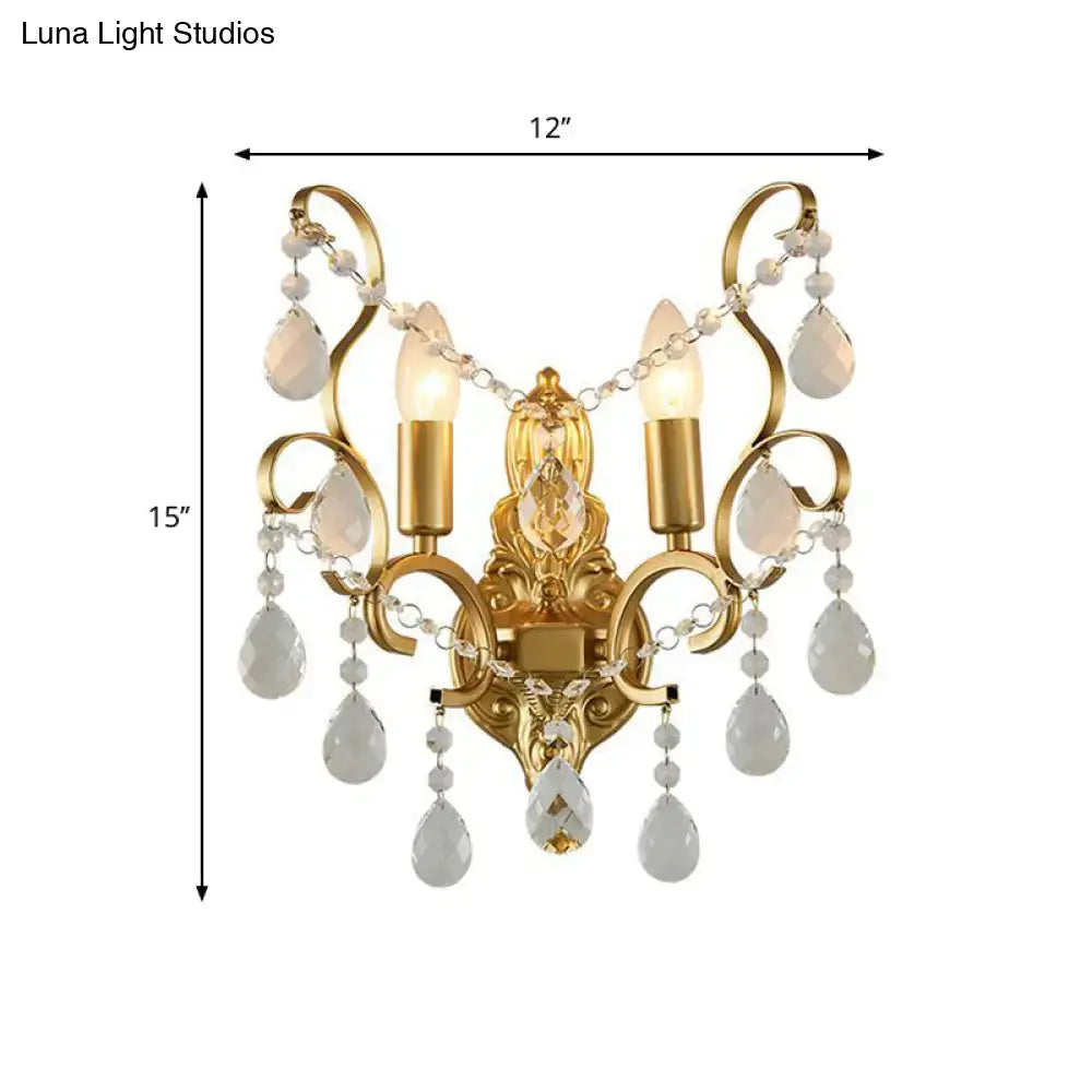 Traditional gold metal candle wall lamp featuring three candle bulbs and dangling crystals for elegant living room decor
