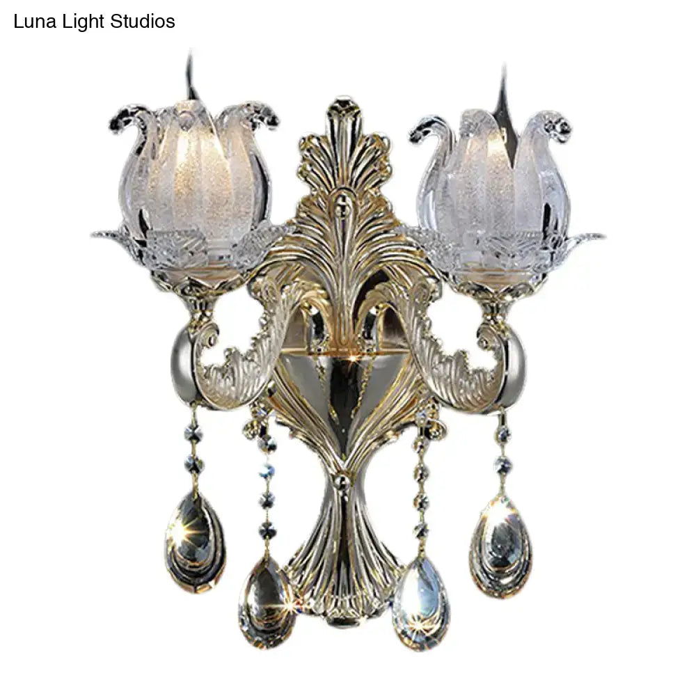 Ornate traditional gold living room wall sconce with frosted glass tulip shades and dangling teardrop crystals