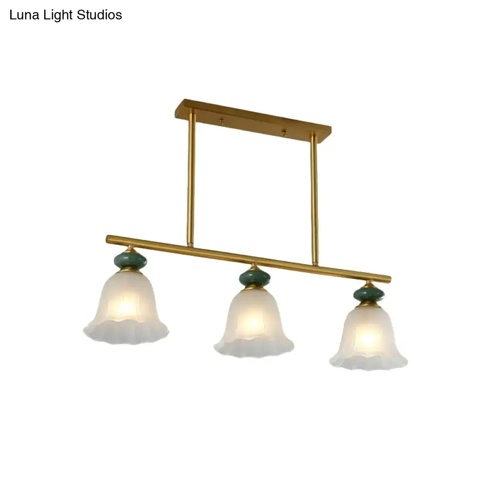 Traditional gold and teal kitchen island light with cream glass shades and green ceramic accents for LED and incandescent use