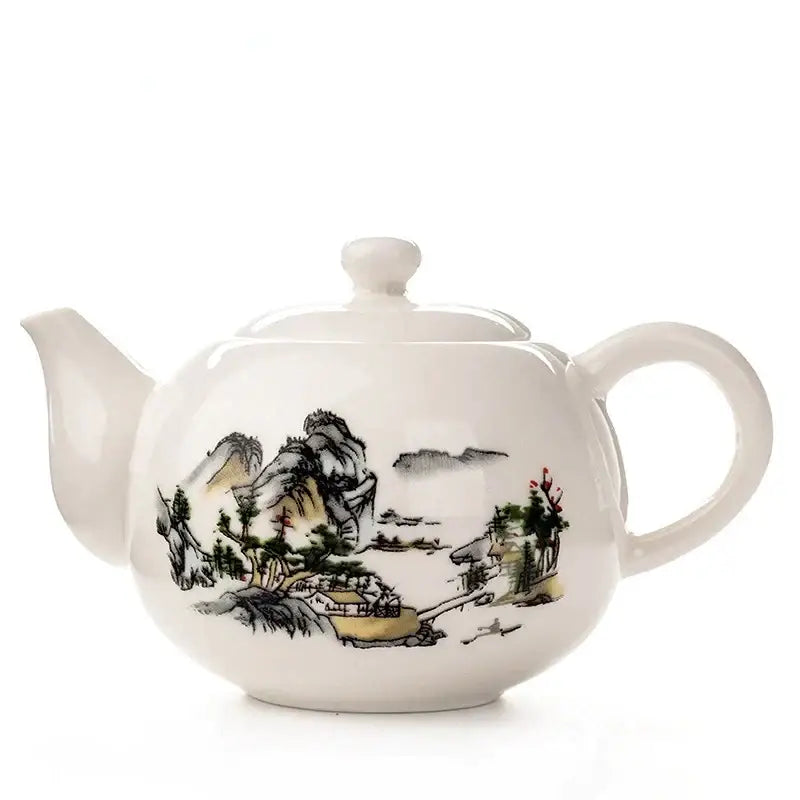 White ceramic dehua clay teapot with traditional east asian ink landscape painting in black green and red decorbites tea set