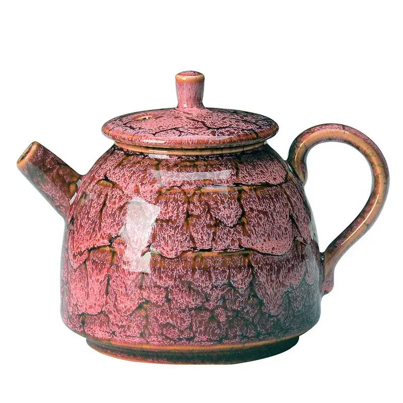 A ceramic kung fu tea pot with crackled pink and brown glaze featuring a rounded body and curved handle for decorbites