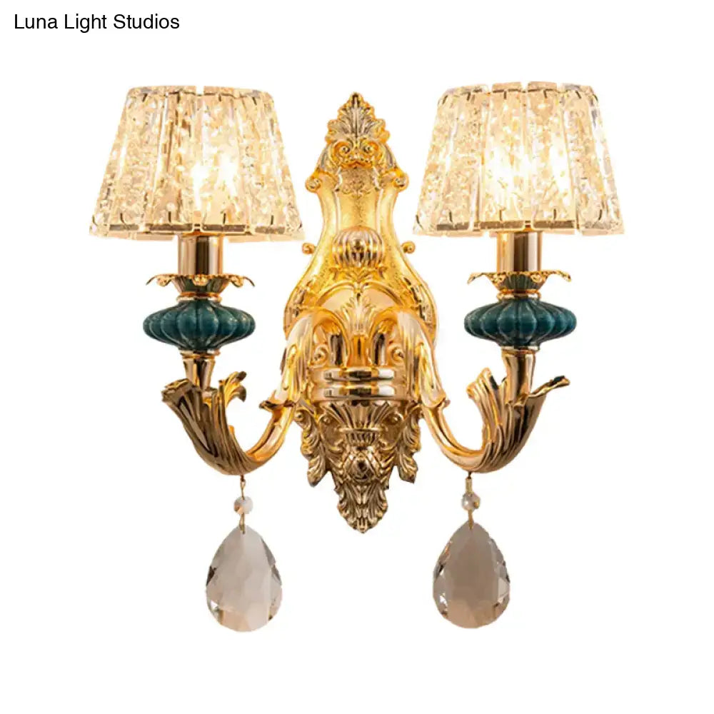 Traditional seedy crystal gold and teal drum wall mount sconce with ornate design and two crystal lampshades for bedroom use