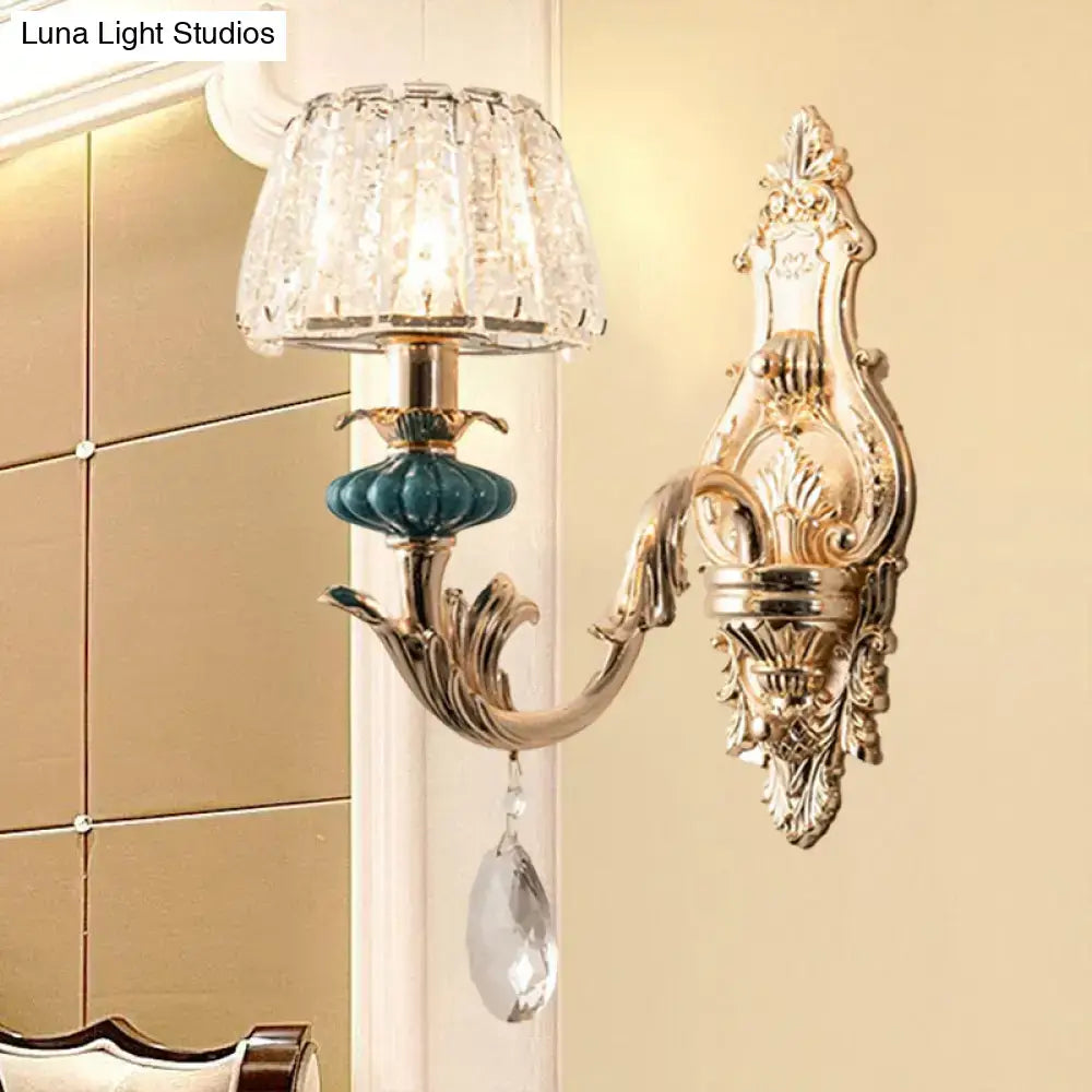 Gold-toned traditional seedy crystal drum wall mount bedroom sconce with crystal shade and teal ceramic accent