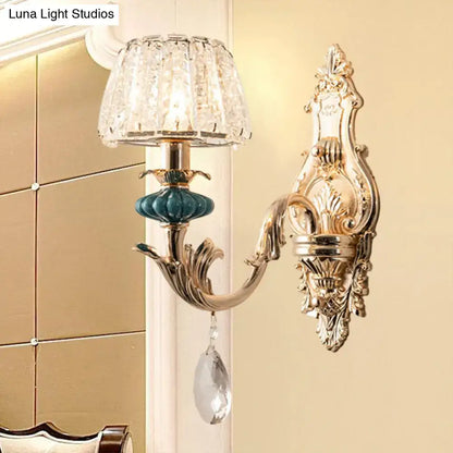 Gold-toned traditional seedy crystal drum wall mount bedroom sconce with crystal shade and teal ceramic accent