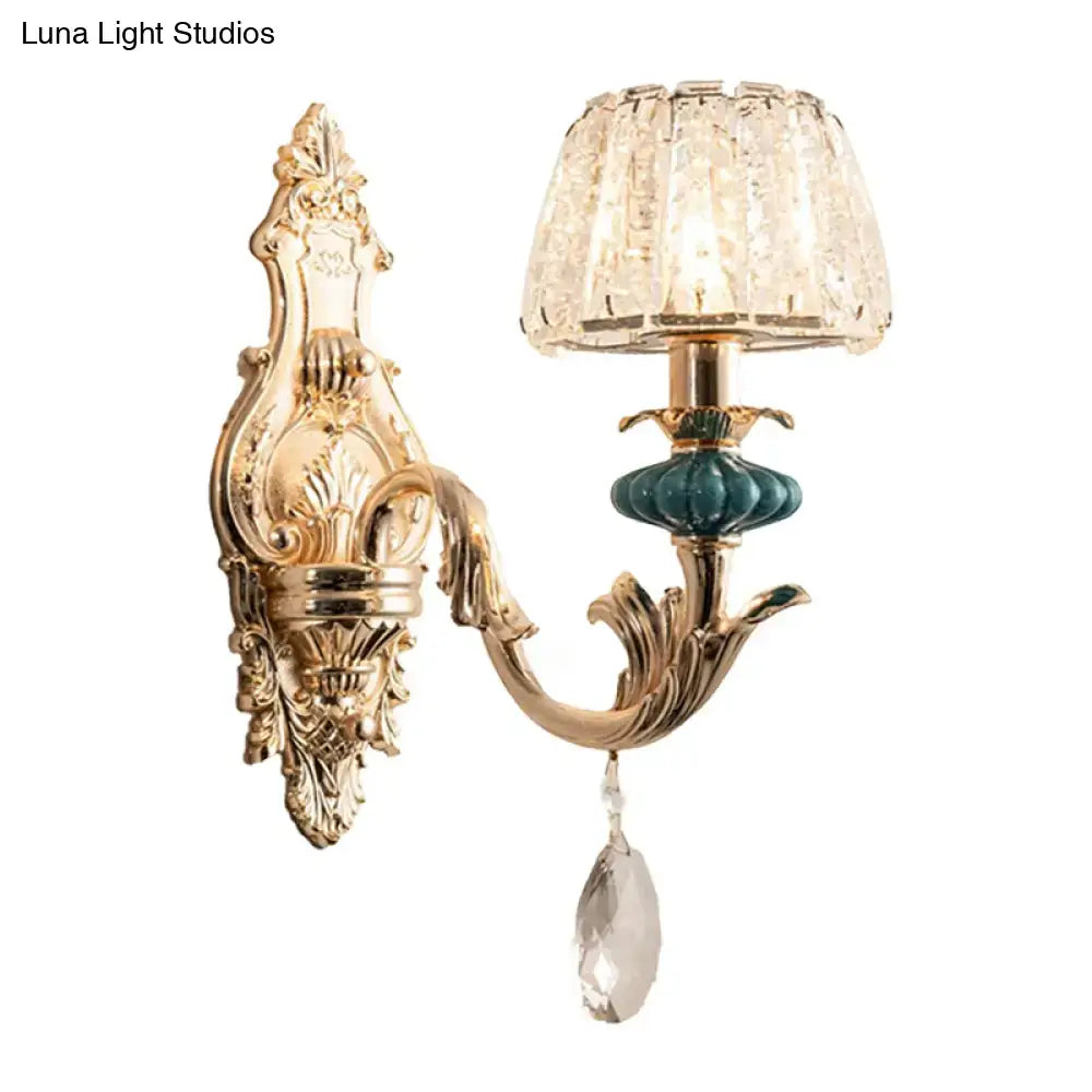 Gold-toned traditional seedy crystal drum wall mount sconce with faceted crystal shade and teal ceramic accent for bedroom
