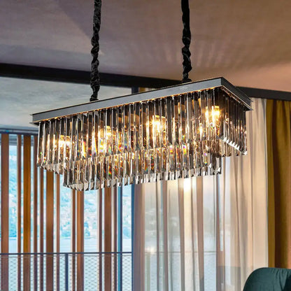 Rectangular smoke gray crystal light fixture with sleek chrome frame and black twisted cords for dining room